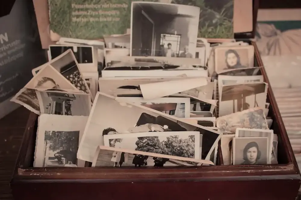 Box of old, fading photographs before digitization.